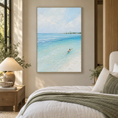One Stroke Toward the Palms: beside a bed with olive pillows and a ceramic table lamp