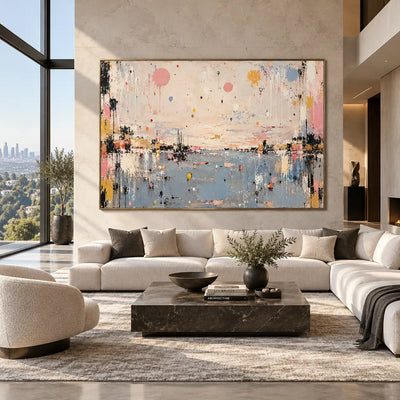 Pastel Drops Above Blue: above a white sectional with a black marble table and tall greenery