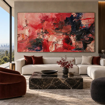 Red Fragments Around a Dark Knot: above a white sofa with burgundy cushions beside a red chair