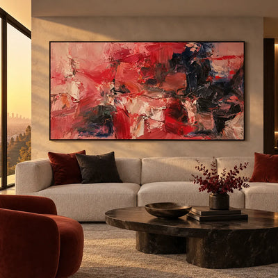 Red Fragments Around a Dark Knot: above a rounded white sofa beside warm sunset glazing