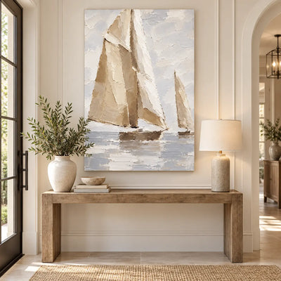 Sails in Soft Light above a wood entry console with a ceramic lamp and leafy vase