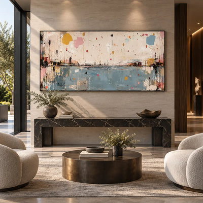 Small Orbits Over Still Blue: above a black marble console between rounded cream chairs