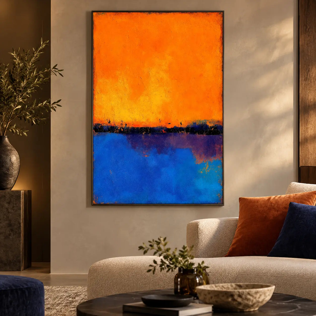 Tangerine over Ultramarine: beside a cream chaise with orange and blue cushions