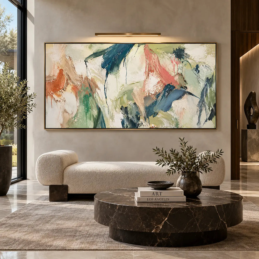 Teal Gestures Through Pale Air: beneath a picture light above a pale bench and round dark table