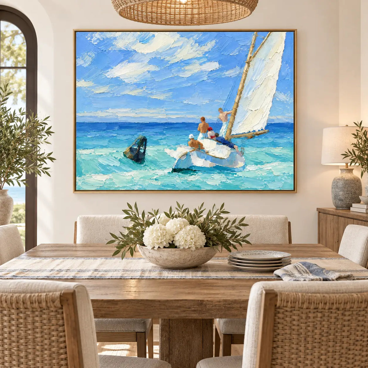 The Blueward Turn above a dining table with white flowers and a woven pendant