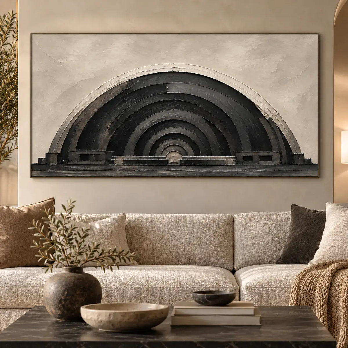 The Charcoal Arcade: above a cream sofa with black and taupe cushions and a dark stone table