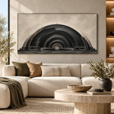 The Charcoal Arcade: above a curved cream sectional and round pale stone table