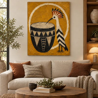 The Crested Drummer: above a cream sofa with two rust cushions and an oval wood table