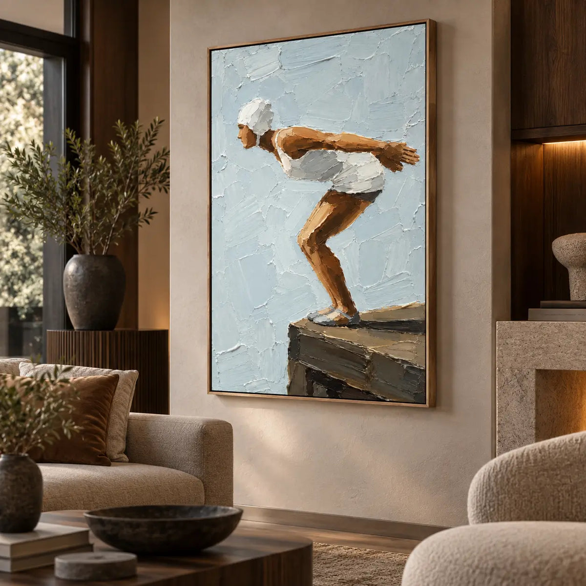 The Moment Before beside a rounded chair near dark cabinetry and a stone table
