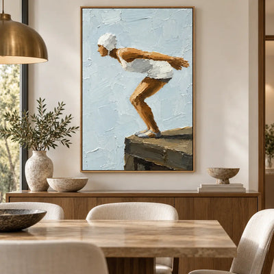 The Moment Before over a dining sideboard beneath a brass pendant and beside white candles