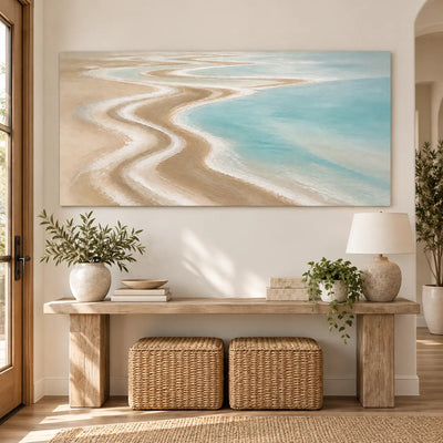 The Shore Draws a Curve: above a light wood console with two woven stools underneath