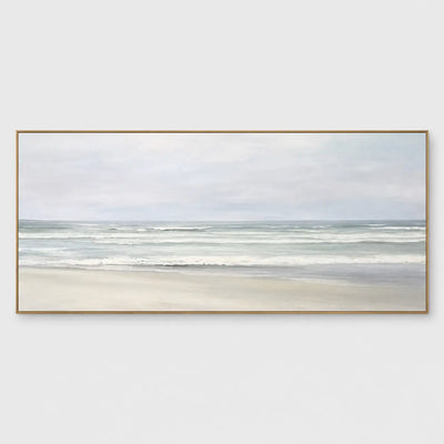 The Shore in Silver Light: Soft gray-green waves approach pale sand beneath an overcast sky