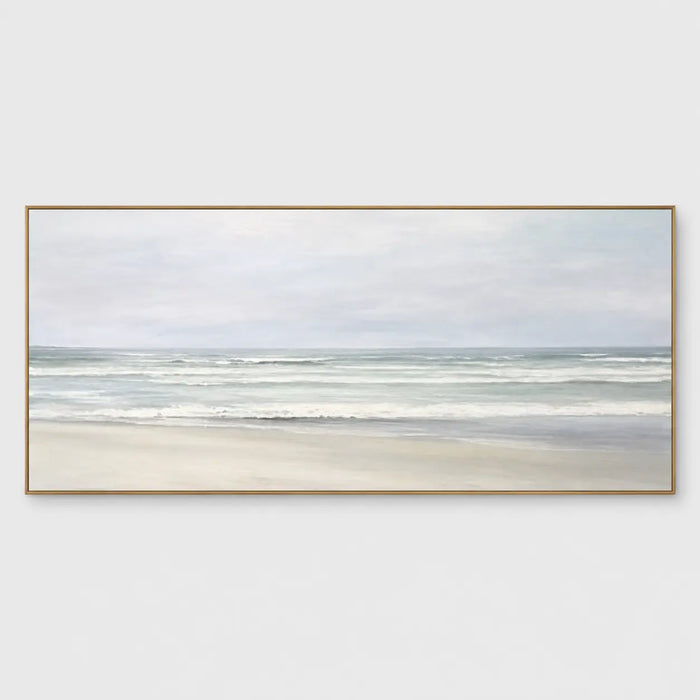 The Shore in Silver Light: Soft gray-green waves approach pale sand beneath an overcast sky