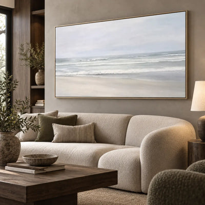 The Shore in Silver Light: viewed obliquely above a rounded ivory sofa