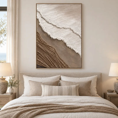 The Umber Shoreline: above a white bed with taupe cushions and paired bedside lamps