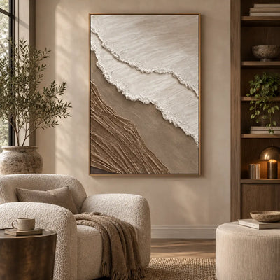 The Umber Shoreline: above a rounded cream armchair near dark wood shelves