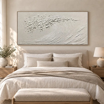 The Uncolored Breaker: above a white bed with a cream bench and taupe throw