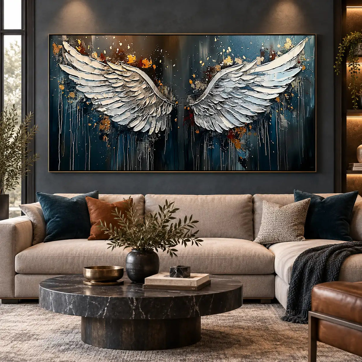 The Unfolding of Wings: above a beige sectional against a dark wall with ceiling spotlights