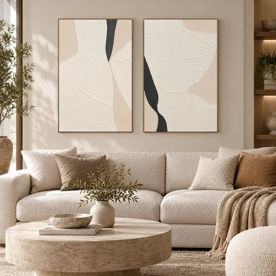 Two Openings in Cream: paired above a cream sofa with tan cushions and a round stone table