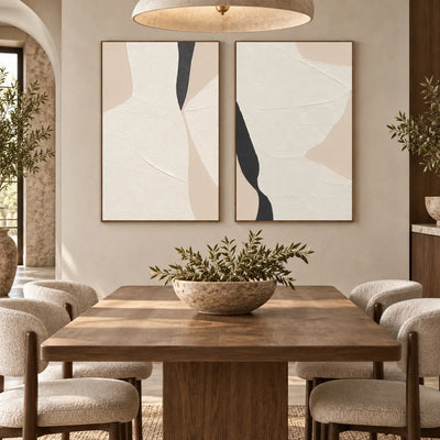 Two Openings in Cream: paired behind a wood dining table beneath a wide pale pendant