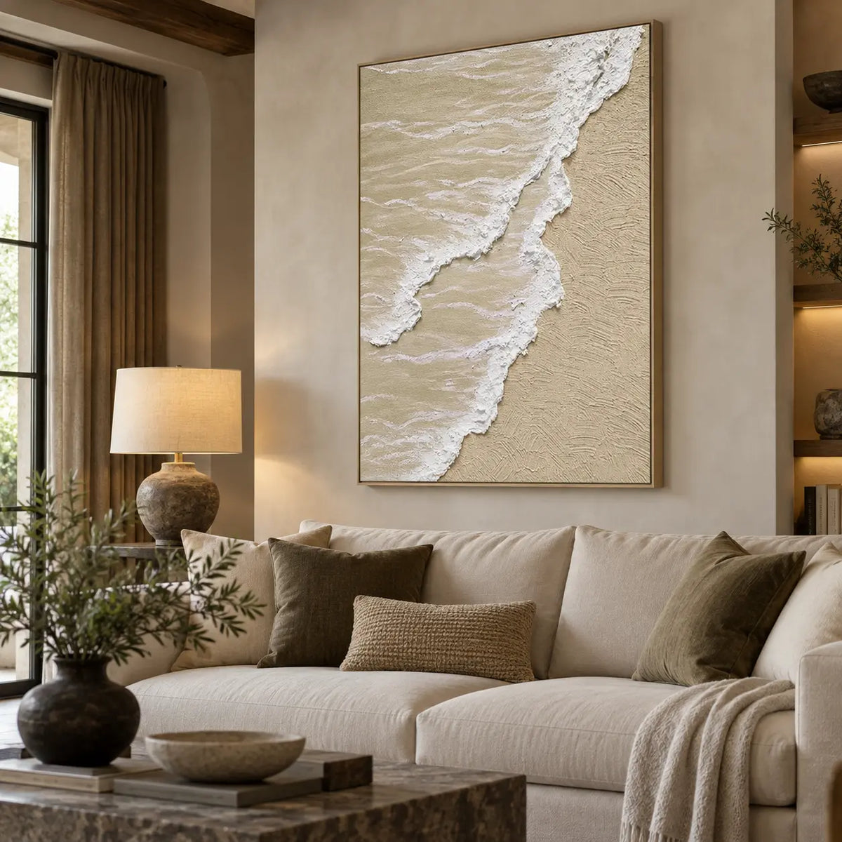 Two Tides on Pale Sand: above a cream sofa with olive cushions beside wood shelves