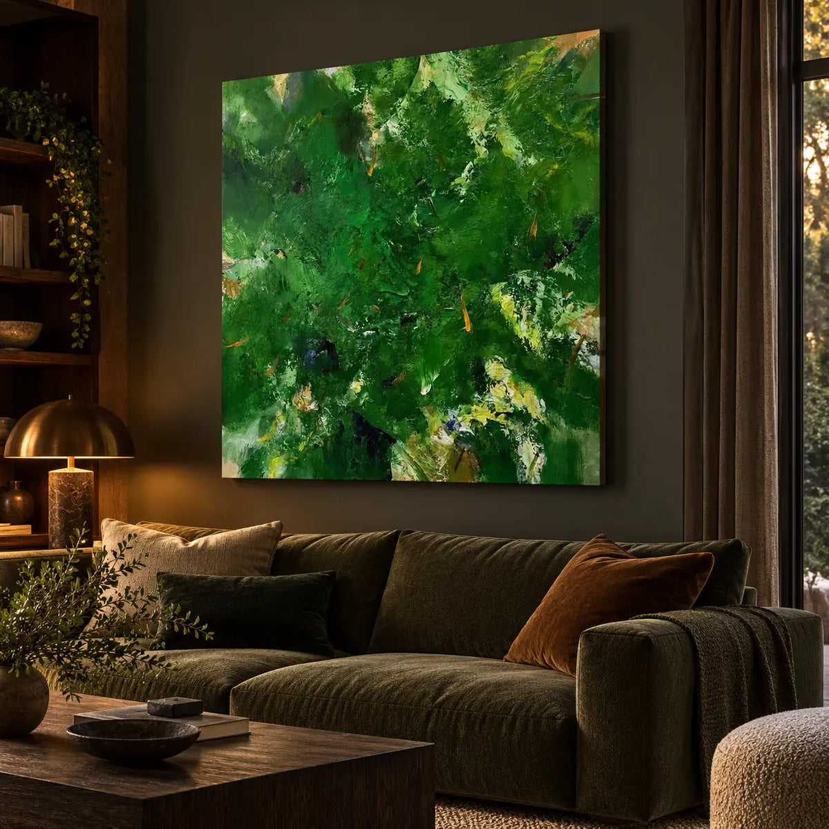 Verdant Immersion: Angled painting view above an olive sofa beside a bookshelf and brass lamp