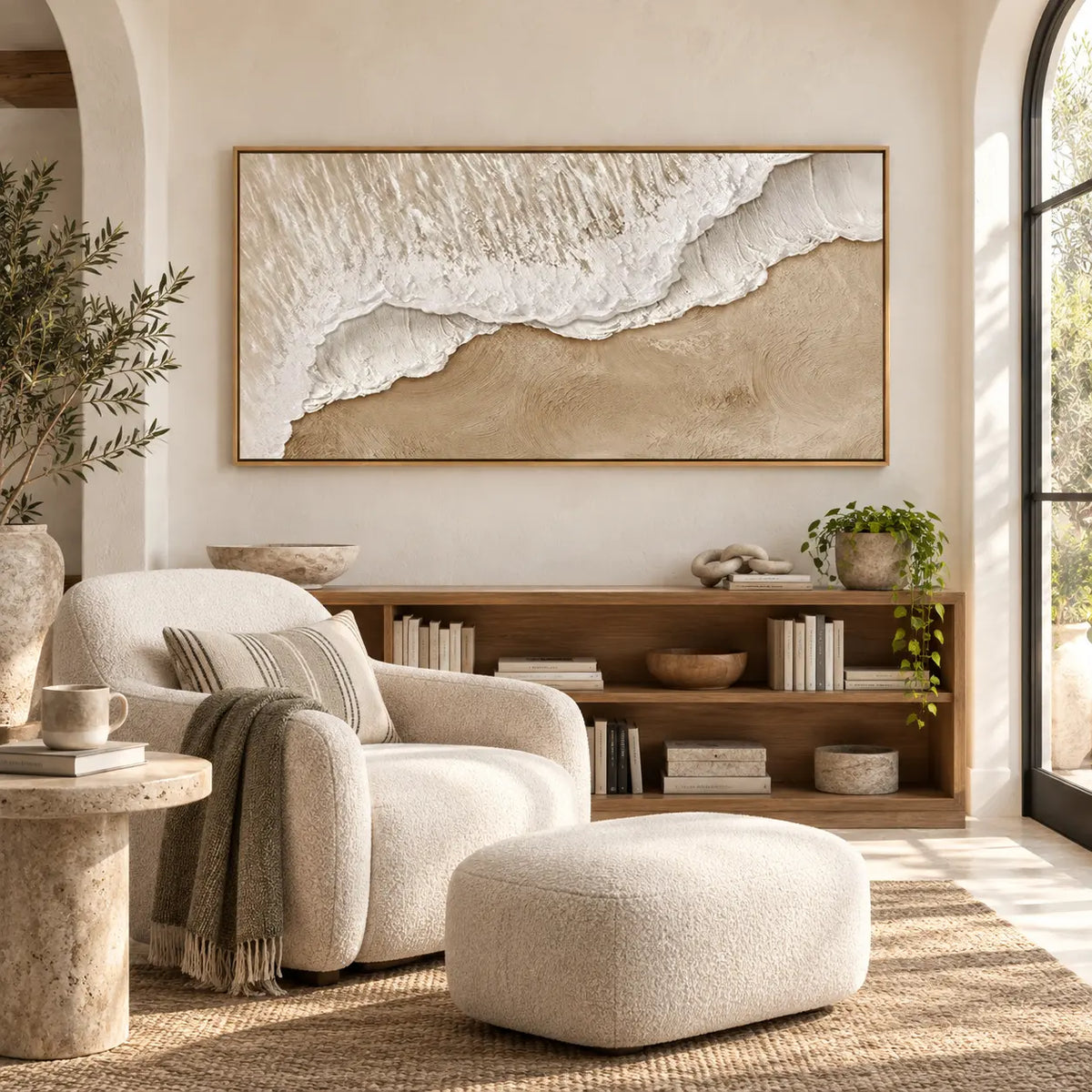 Where Foam Meets Sand: above a low bookcase beside a cream reading chair and ottoman