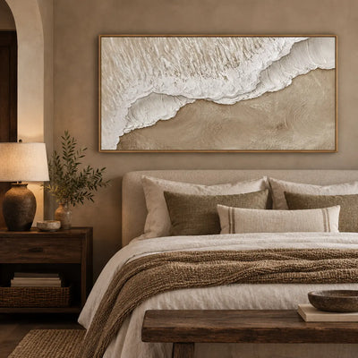 Where Foam Meets Sand: above a bed in warm lamplight with a dark wood bedside table