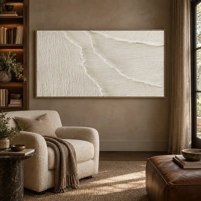 Where the Fine Lines Turn: in a reading room with a cream armchair and brown leather ottoman