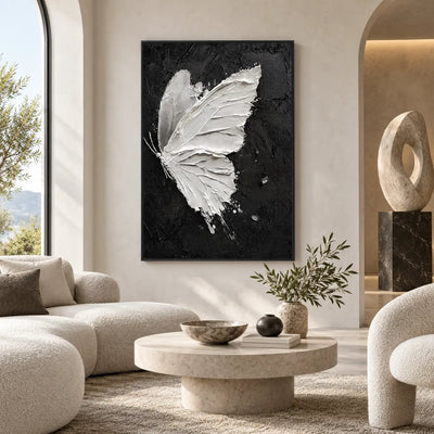 Wings Against Midnight: in a bright room with rounded ivory seating and a stone table